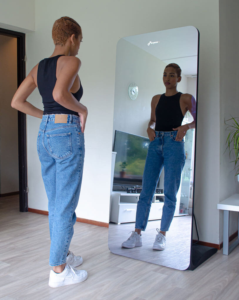 Person standing in front of the AI smart mirror